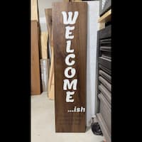 Walnut entry sign with white lettering